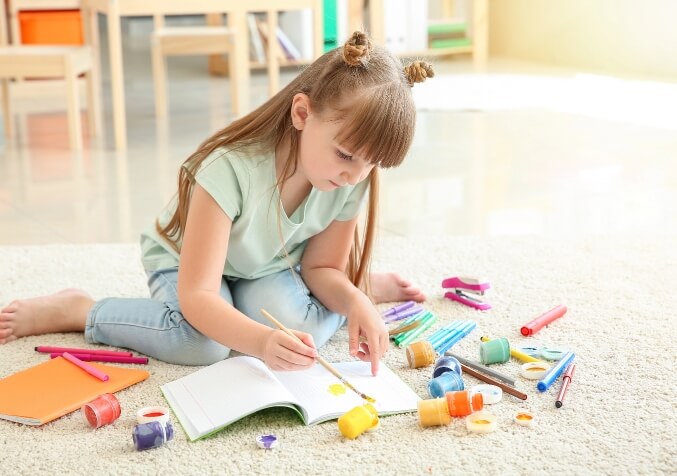 Child doing Drawing, Arts and crafts on Carpet