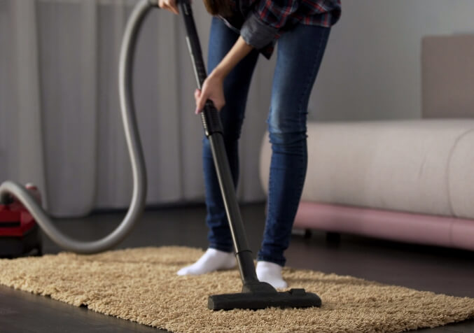 Woman Vacuuming Rug