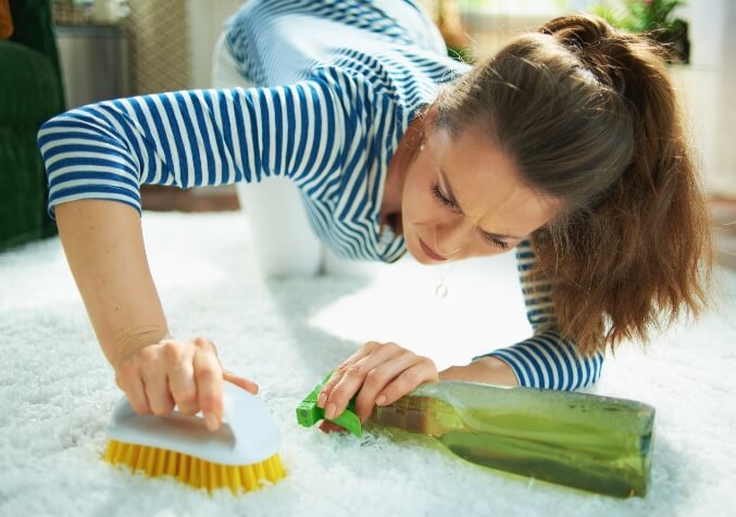 Woman Having a Difficult time Cleaning Carpet