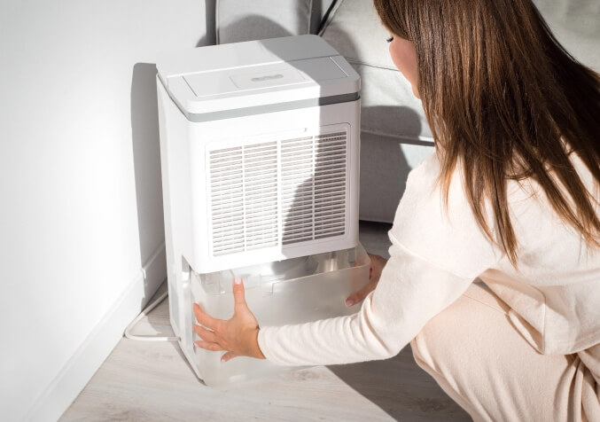 Woman Emptying out dehumidifier
