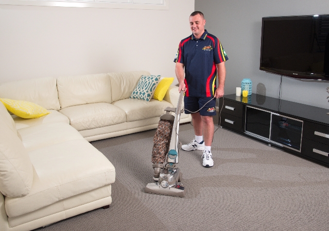 Electrodry Technician vacuuming carpets before cleaning