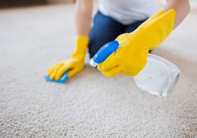 Spraying in Carpet with Yellow Protection Gloves